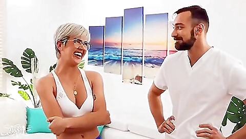 Blonde shemale gets oiled up by a guy in a massage room